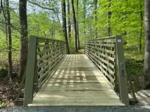Olive green FRP truss bridge installed on the Watkins Spicebush Trail in Maryland.